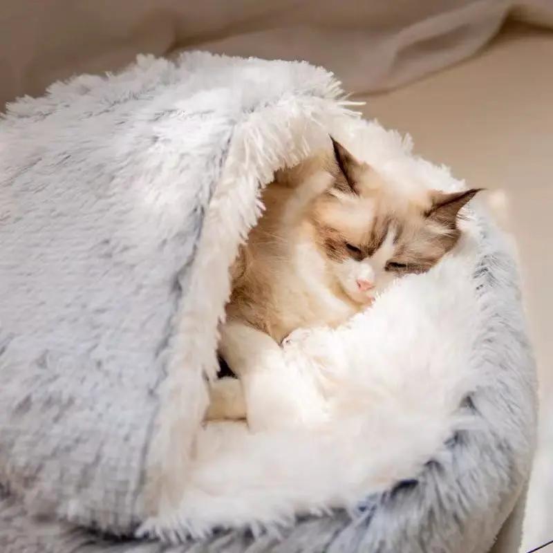 Semi-closed plush cat bed with a gray fur shell, a cat nestled inside.