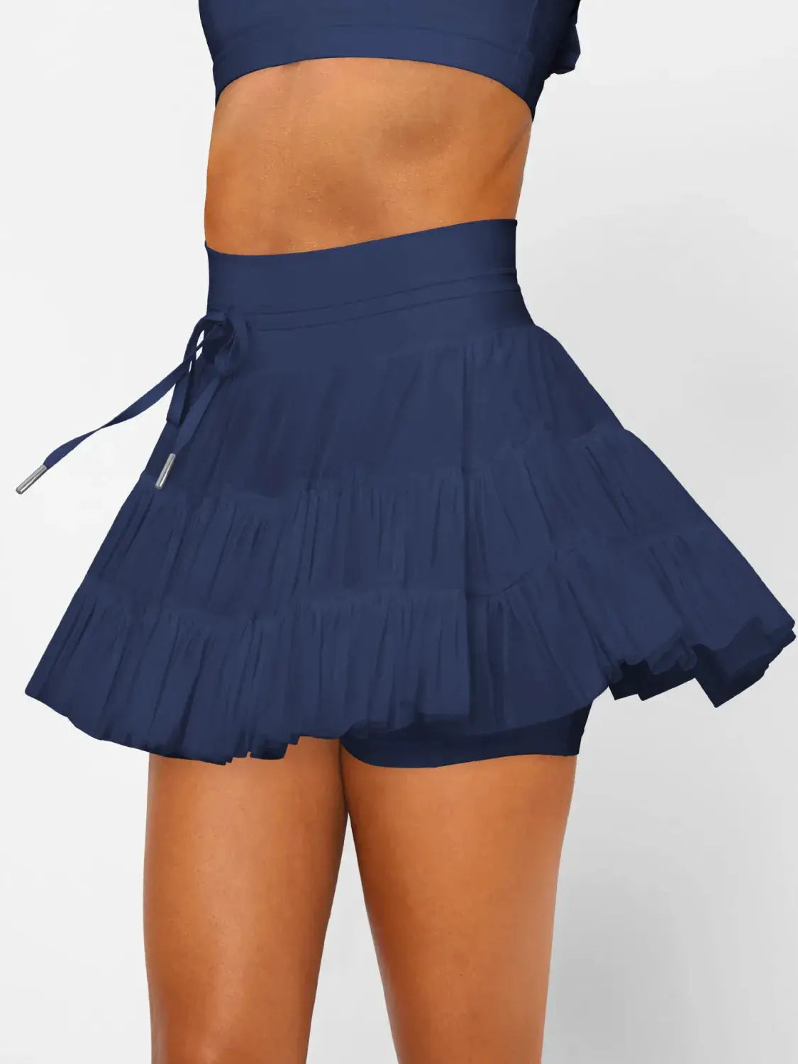 Ruched mini skort with pockets by Trendsi in navy blue; tiered ruffle design with drawstring waist.