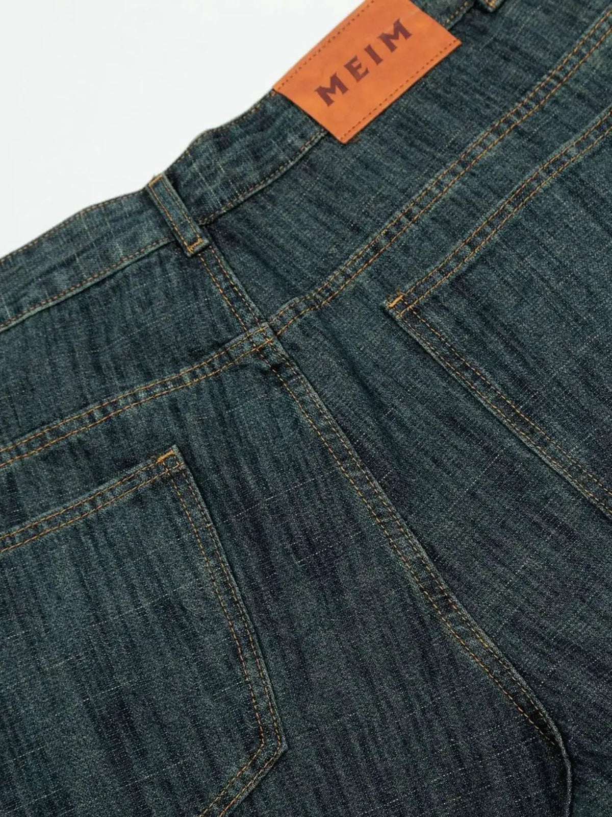 Mens relaxed fit denim shorts in blue cotton blend with orange MEI patch