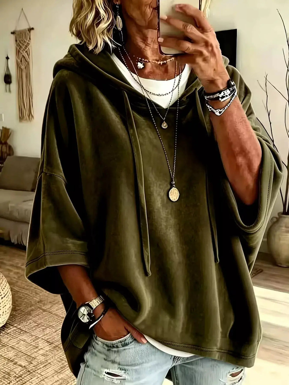 Velvet Loose Fit Hoodie with Drawstring in olive green, worn over a white tee.