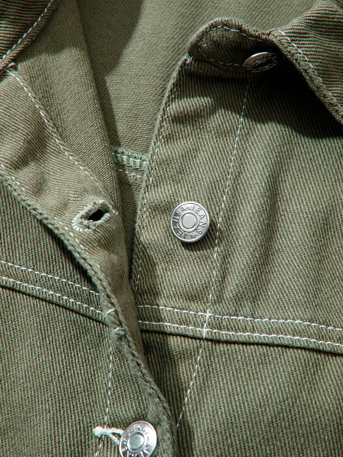 Boyfriend denim jacket in olive green with metal button closures and visible stitching.