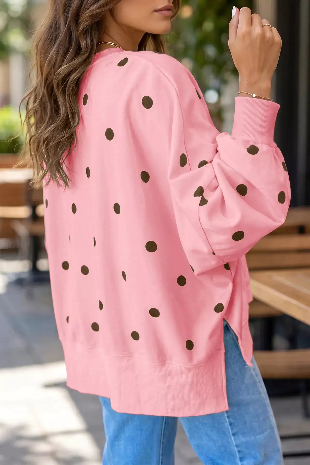 Side Slit Polka Dot Oversized Sweatshirt in pink with black dots, paired with blue jeans.
