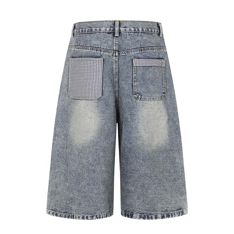 Denim shorts by eprolo, blue-washed back view with two pockets and a plaid patch on the left pocket, belt loops.