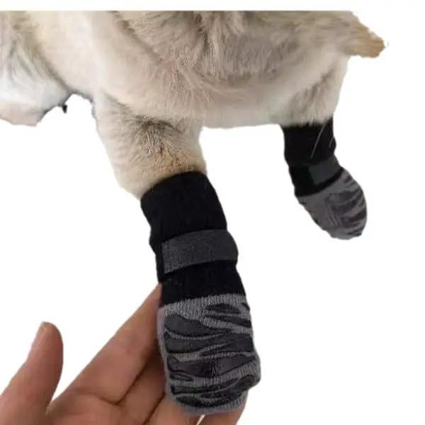 Pet dog outdoor non-slip waterproof sock shoes by AdTec, gray and black striped pair on paws