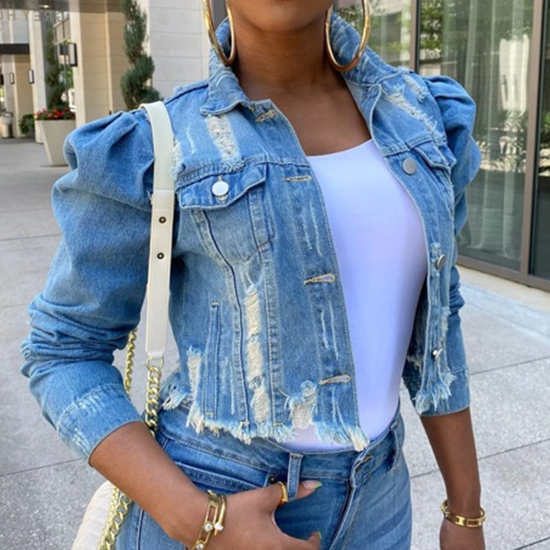 Short distressed denim jacket for women, light blue cropped trucker style with frayed hems and puff sleeves.