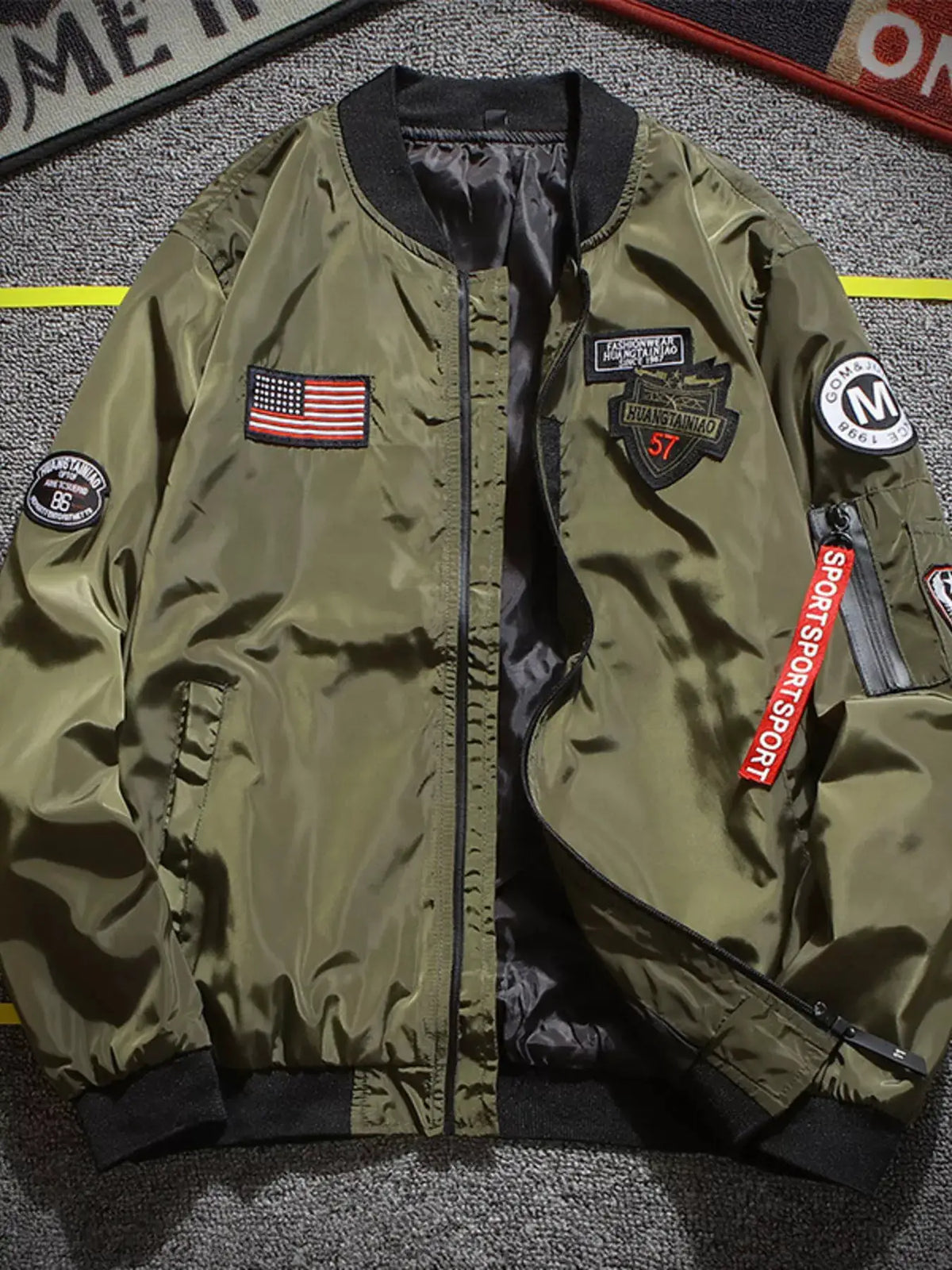 Men's Plus Size Military-Inspired Patched Bomber Jacket, olive green with black ribbed cuffs and American flag patch.