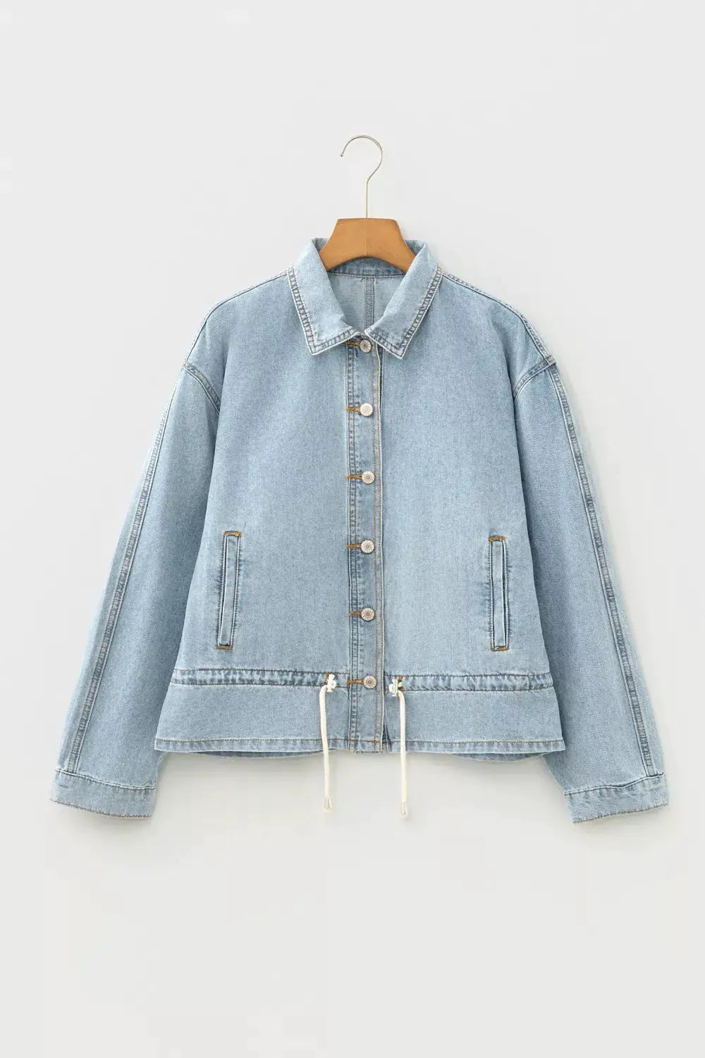 Classic light wash denim trucker jacket by Trendsi with adjustable drawcord hem and front button closures