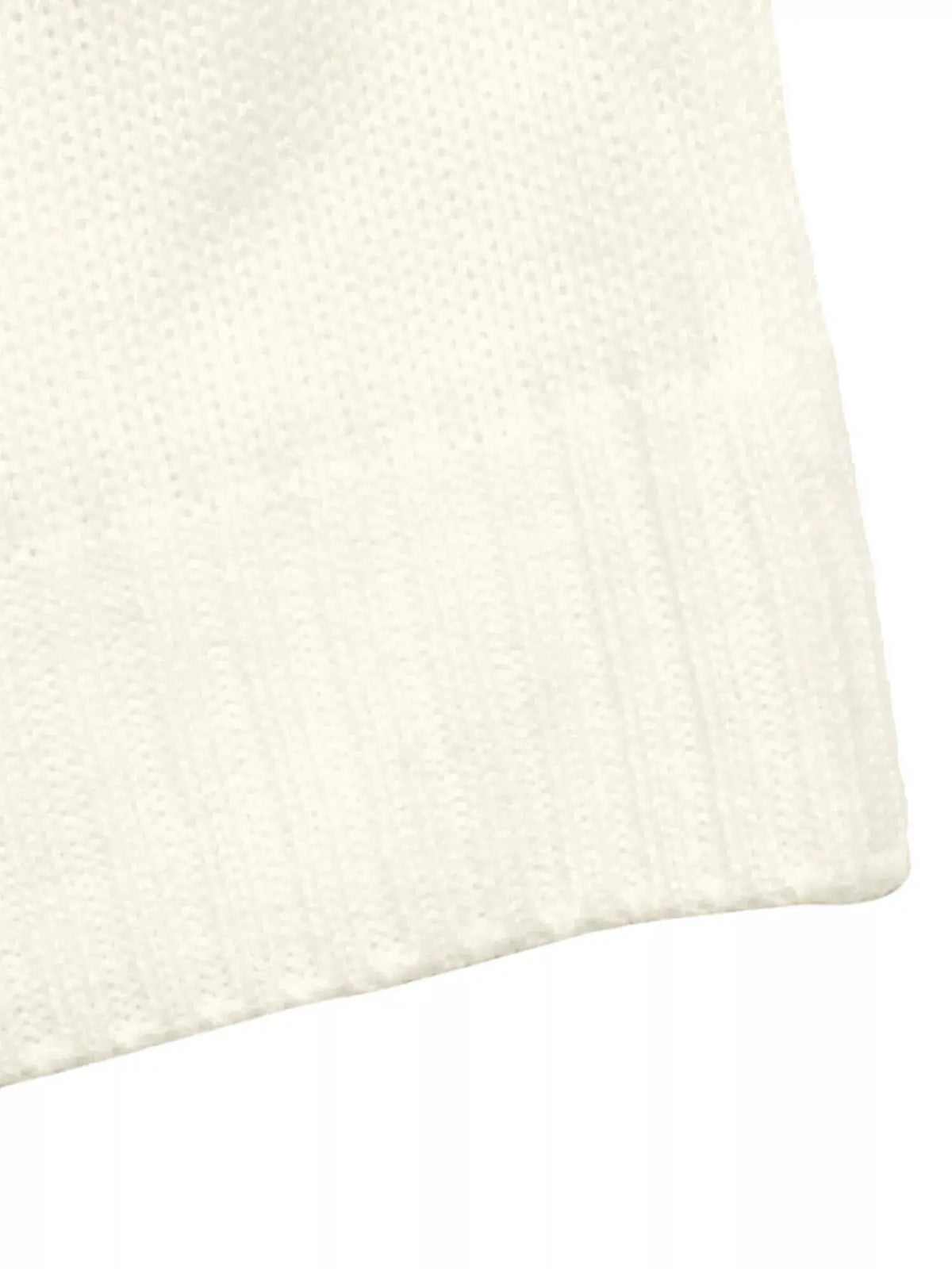 White acrylic knit sweater close-up with ribbed hem
