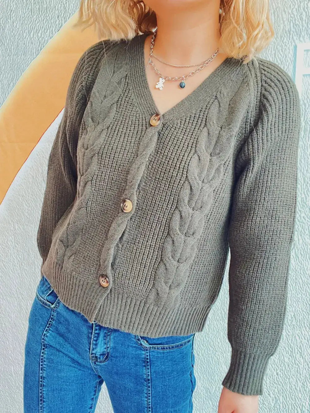 Cardigan, soft gray cable-knit with V-neck, button-front, long sleeves.