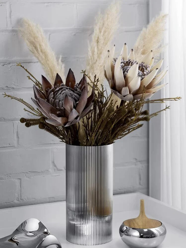 Stainless steel ribbed vase with dried flower arrangement for Nordic home decor.
