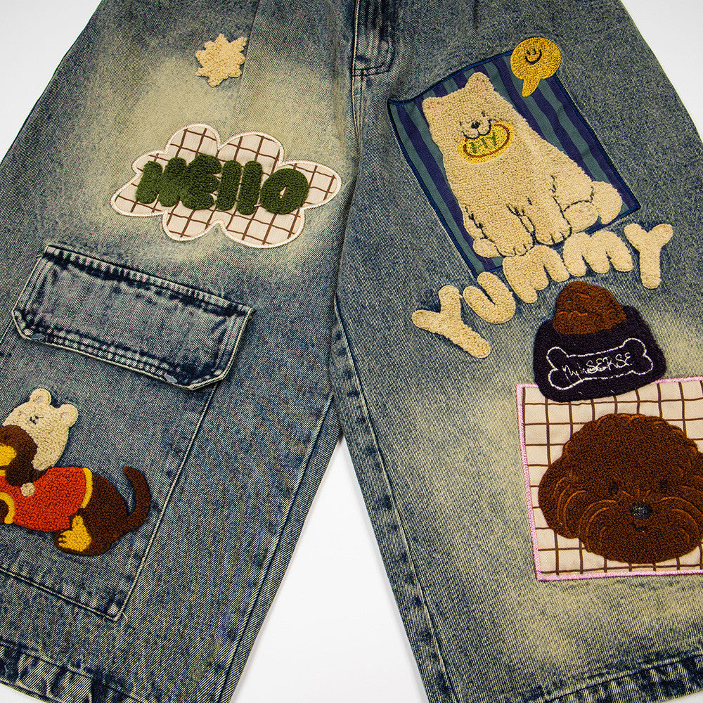 Denim shorts with colorful embroidered patches on a light distressed wash