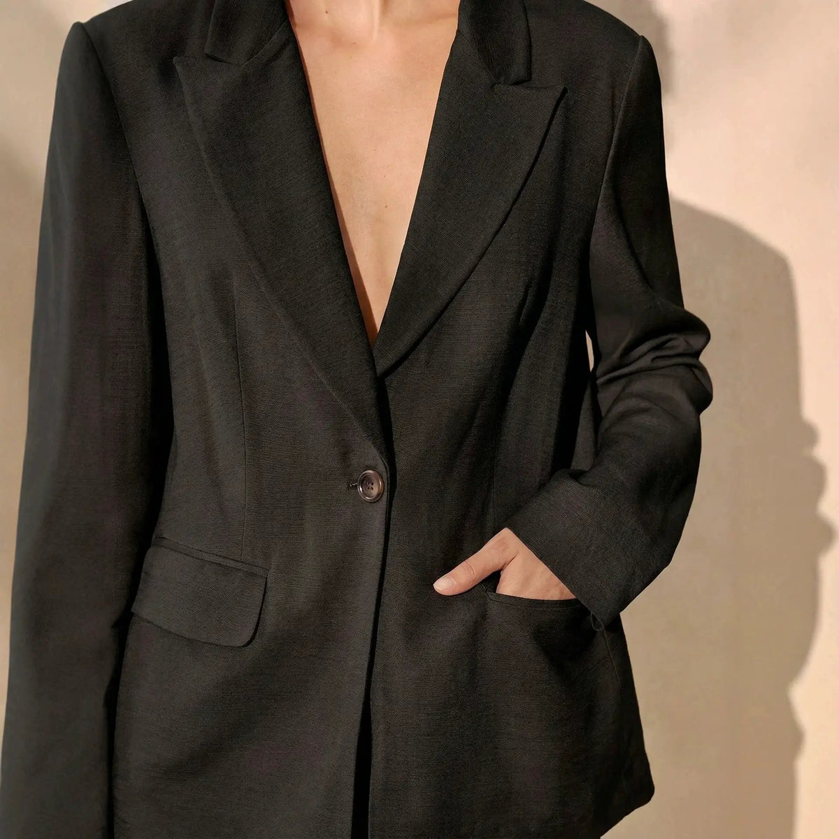 Blazer by eprolo in black with notched lapels, single button closure, and front pockets.