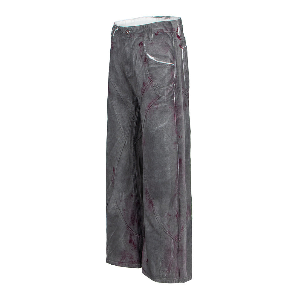 Distressed dyed denim jeans by eprolo, grey wide-leg pants with red splatter accents