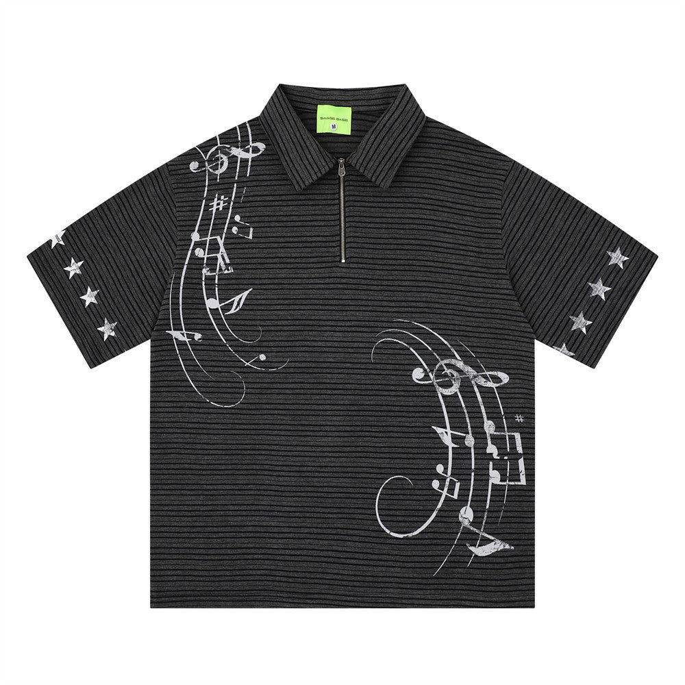 Black striped short-sleeve polo with white musical-notes graphic, zip collar, and star accents on sleeves.