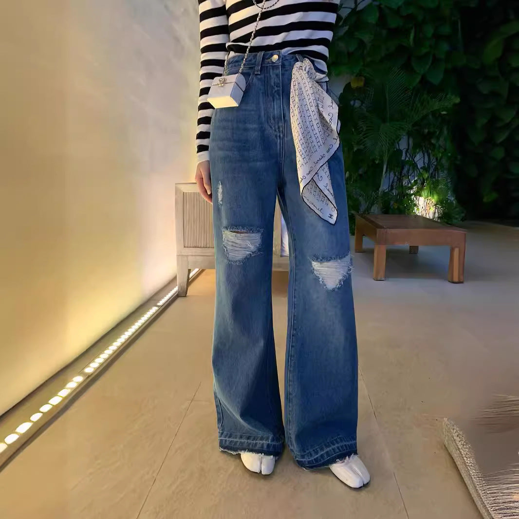 Layered ripped wide-leg jeans for women with distressed patches in blue denim