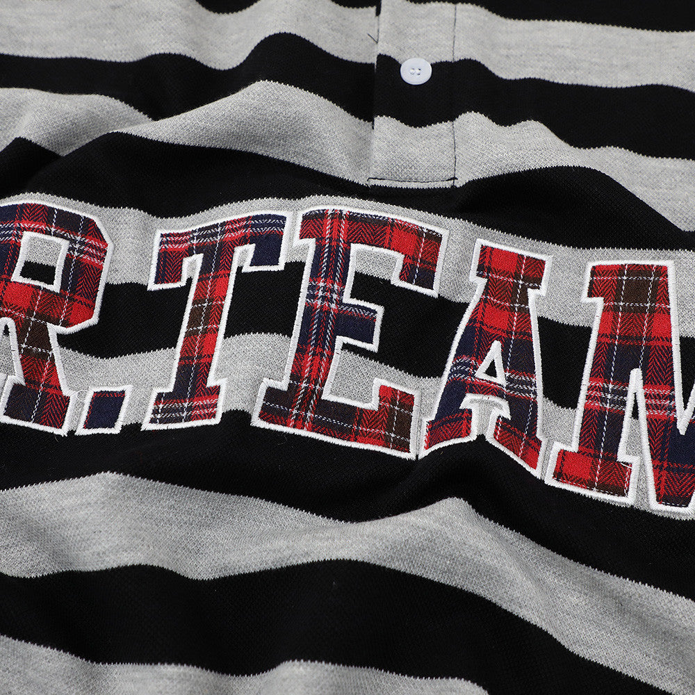 Polo shirt with black and gray horizontal stripes and plaid-filled letter applique across the chest