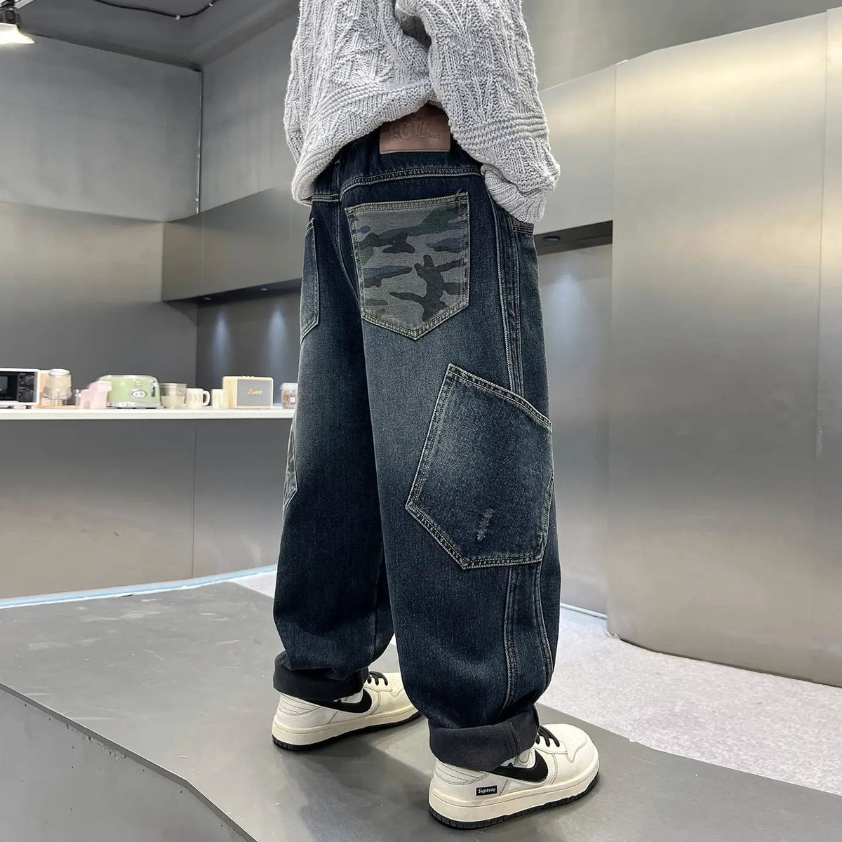 Boys casual denim jeans, loose straight leg, dark wash with camouflage back pocket and rolled cuffs.
