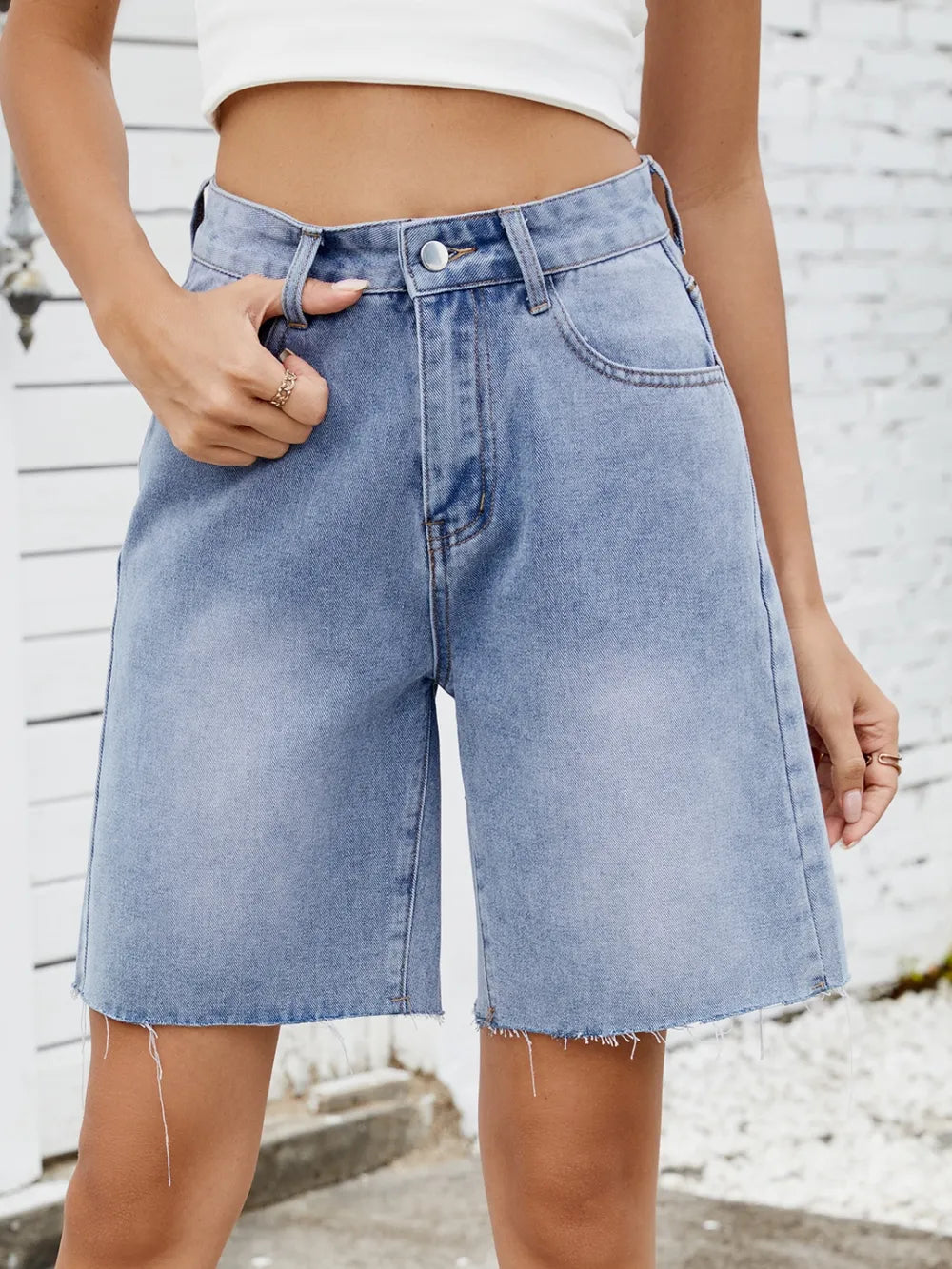 Washed raw-hem denim shorts by eprolo in light blue.