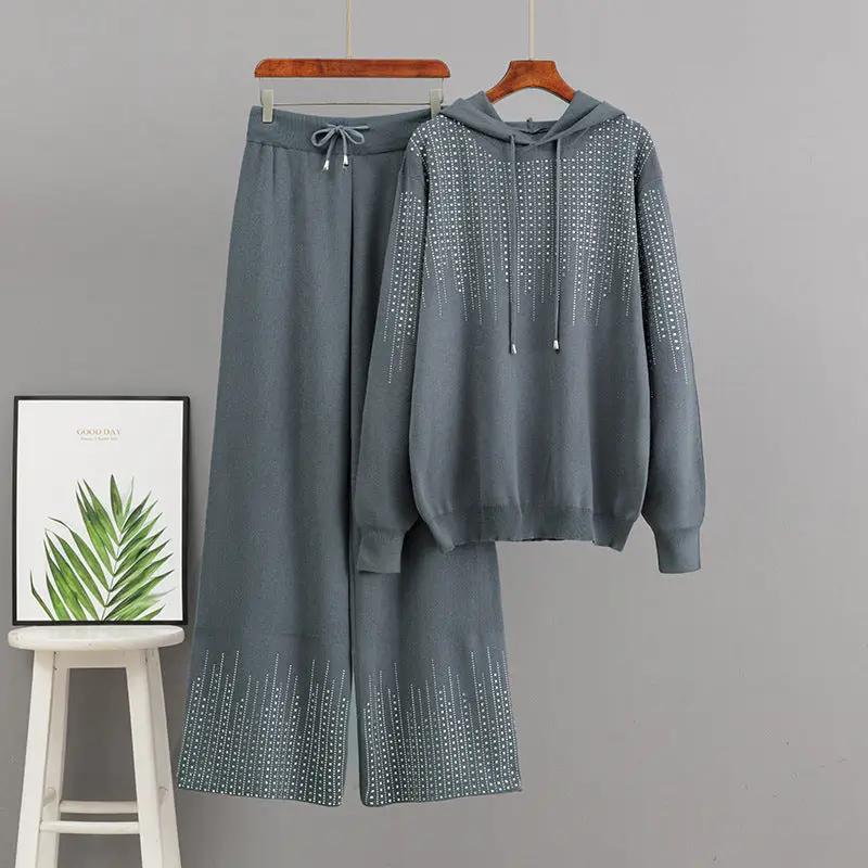 Oversized knit sweater top and matching pants set by eprolo; blue-gray with bead-dotted detailing.