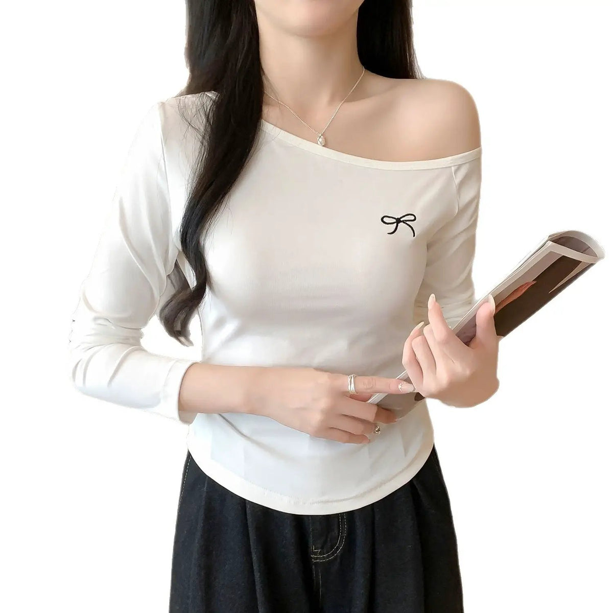 White long-sleeve asymmetric-shoulder inner T-shirt with a small black bow embroidery