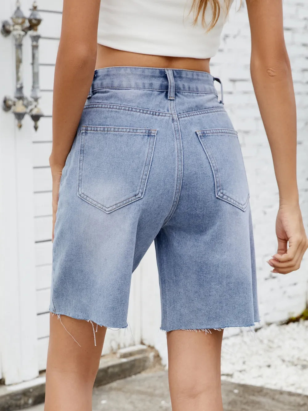 Washed Raw Hem Denim Shorts by eprolo, light blue denim with frayed hems and two back pockets.