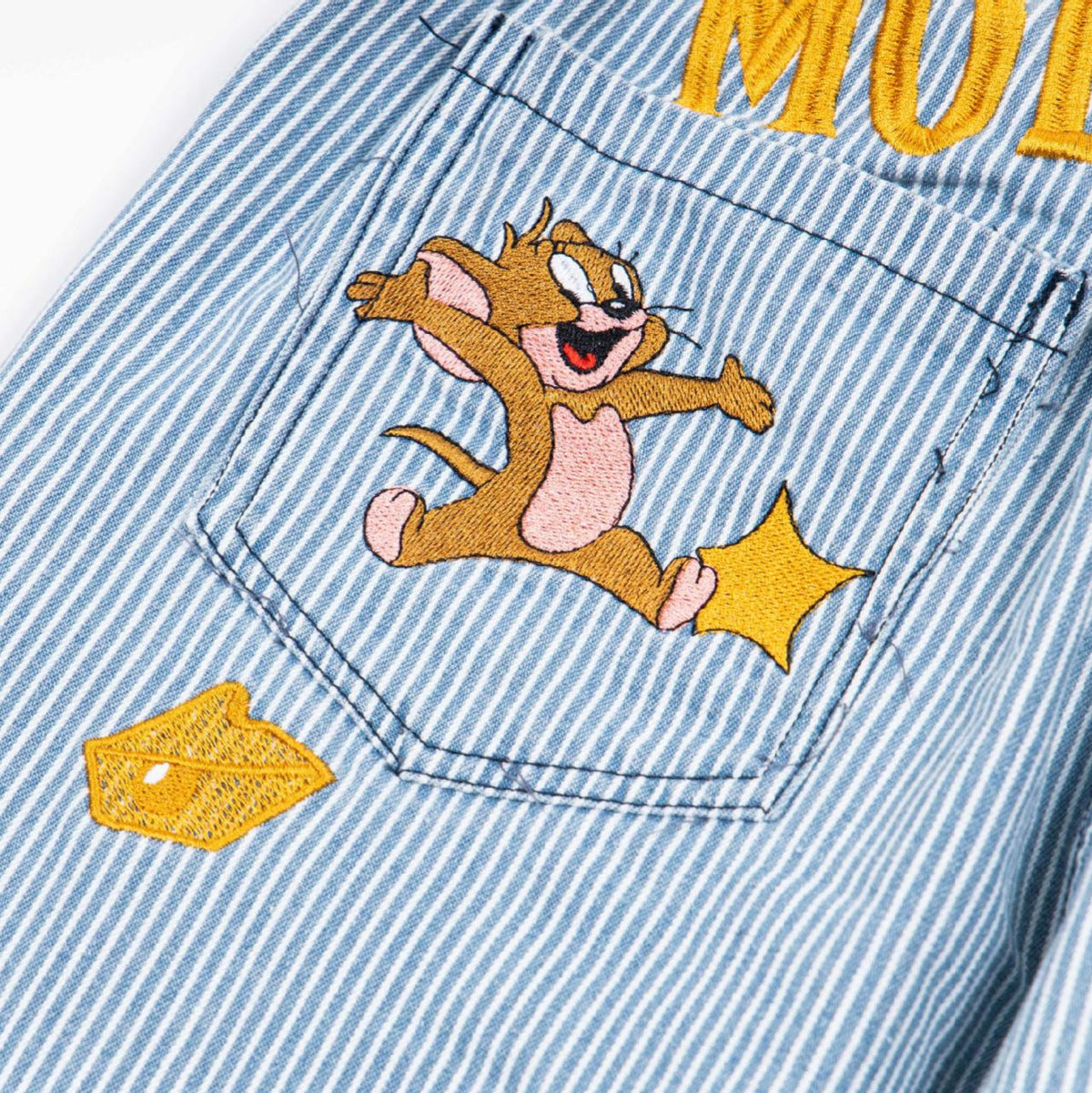 Washed striped denim jeans by Eprolo with back-pocket cartoon mouse embroidery and yellow patch.