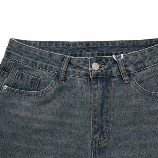 Jeans waistband close-up in blue denim cotton with belt loops and metal button
