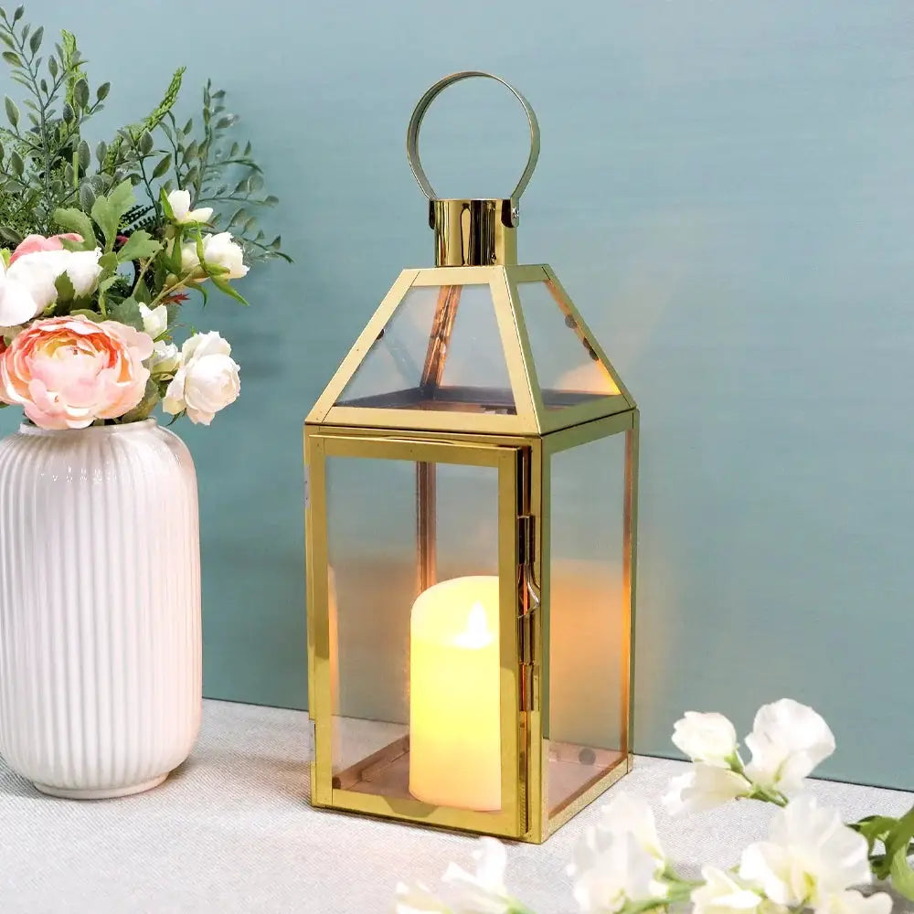 16 inch High Decorative Lantern with gold-tone frame, glass panels, and a candle inside