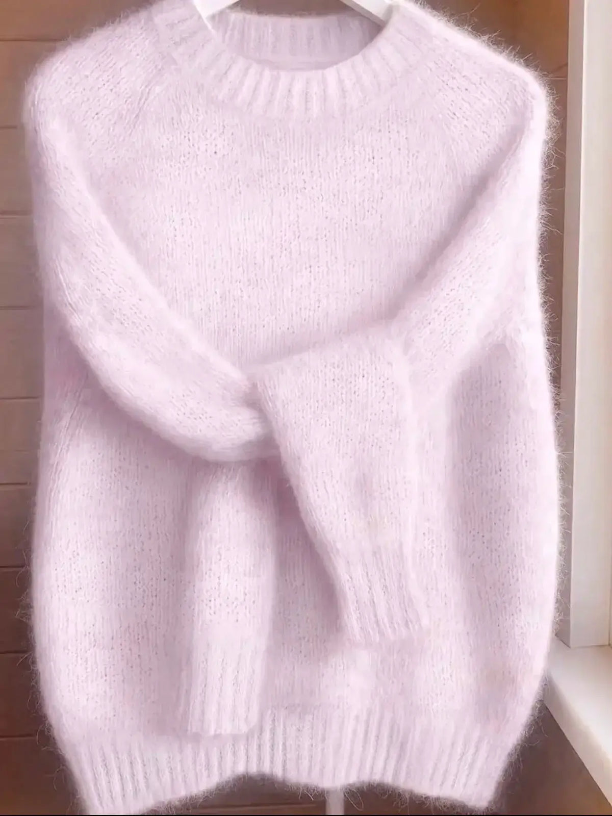 Womens soft cozy knit sweater in pale pink with fluffy texture