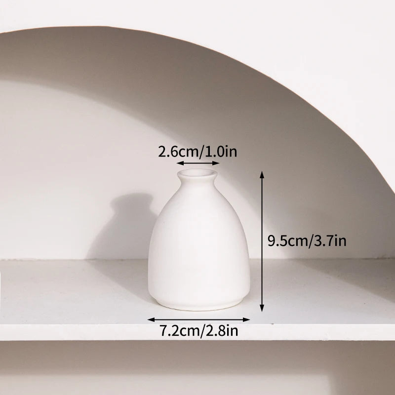 Ceramic flower vase by PrimeCanada.Store; white, 9.5cm tall with 7.2cm base.