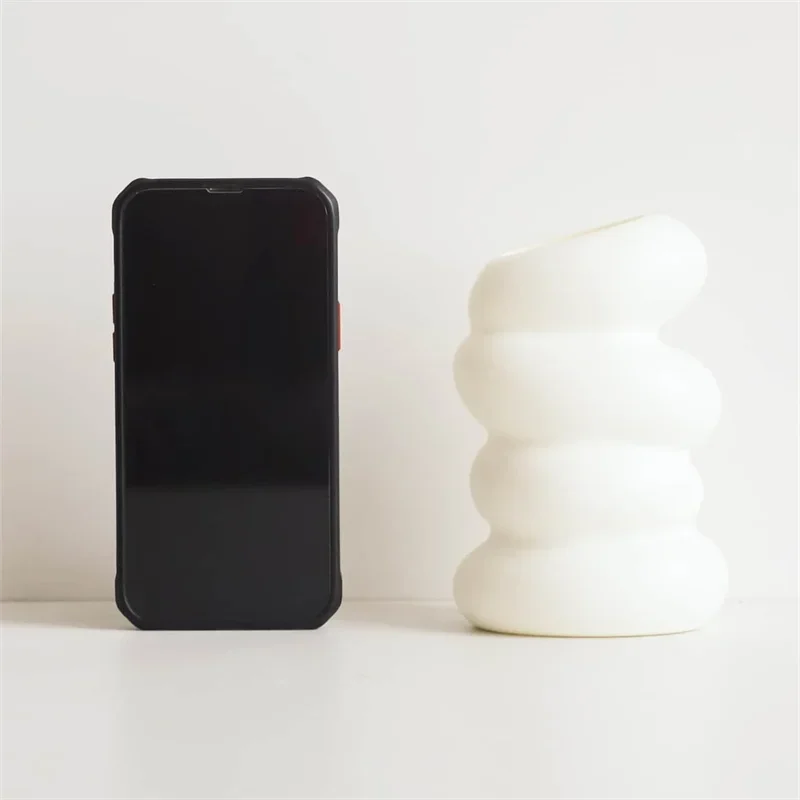 Plastic spiral white vase beside a smartphone; Nordic-style decor by PrimeCanada.Store.