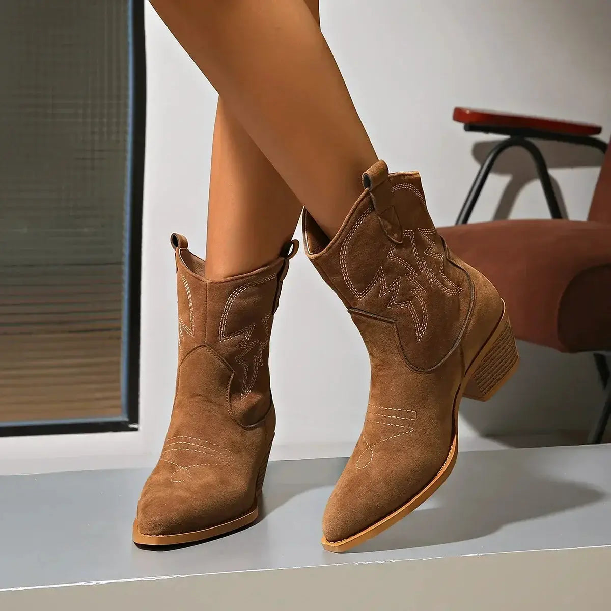 New women's Western-style ankle boots pair in brown suede with decorative Western stitching and a stacked heel