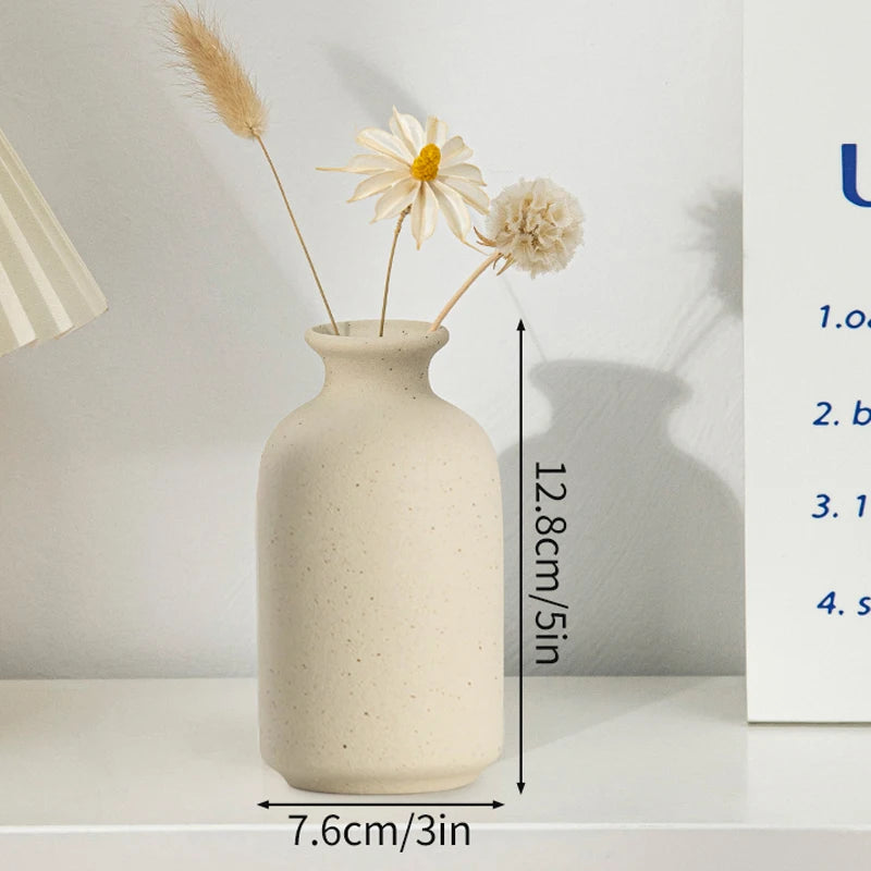 Ceramic flower vase with beige speckled finish holding dried flower stems