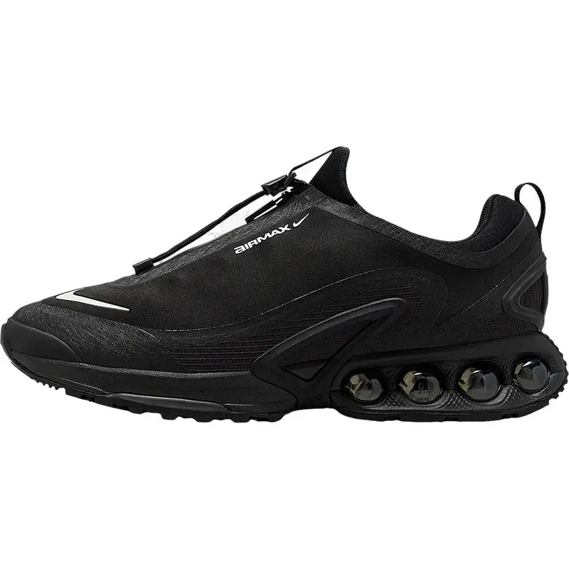 Nike Air Max Roam men's black low-cut sneaker with visible bubble sole and pull tab.