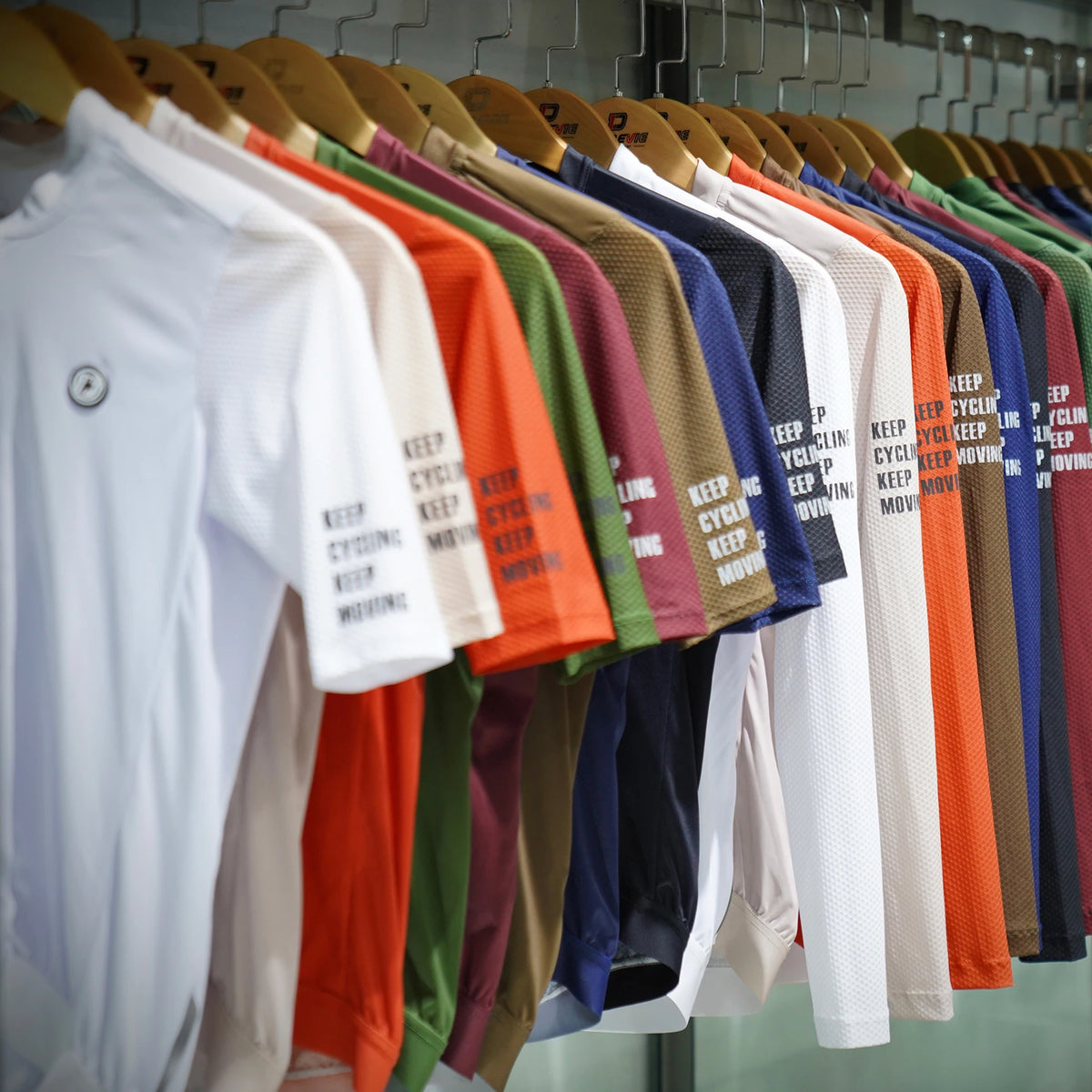 DAREVIE SPF50 long-sleeve cycling jersey on display in assorted colors