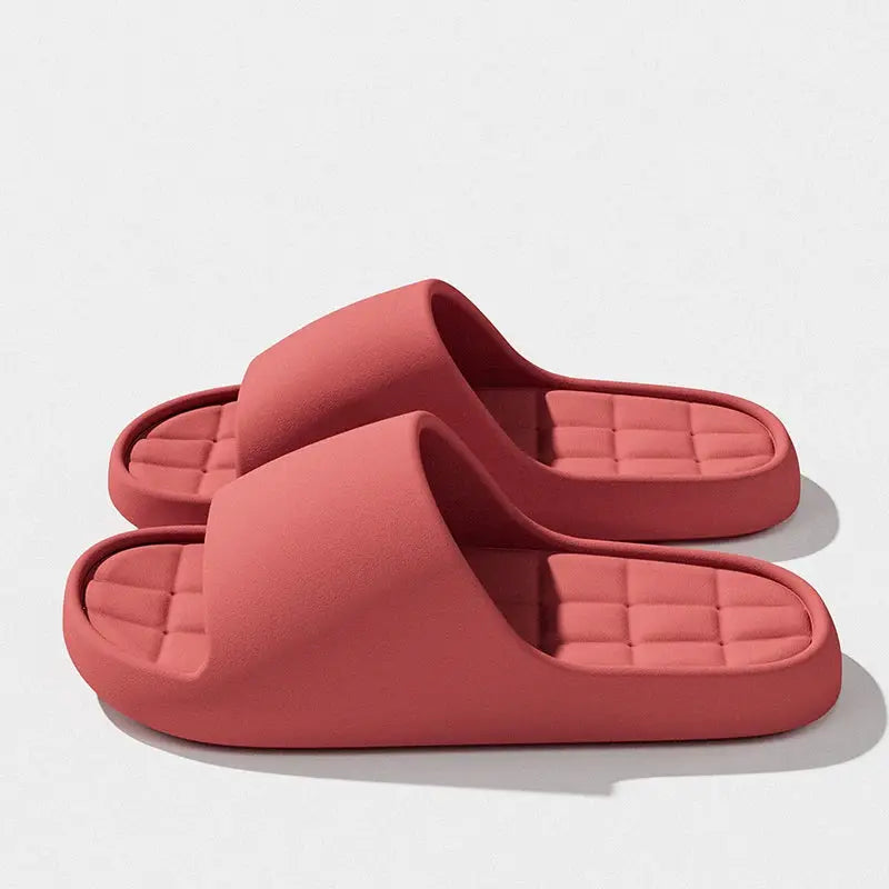 Pair of pink unisex slides with cushioned quilted footbed.
