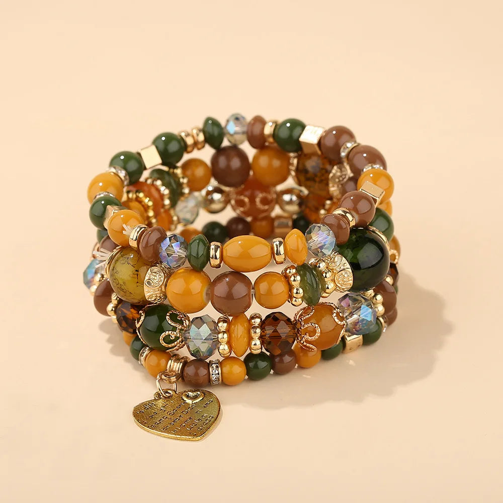 Boho crystal heart bracelet set; stackable elastic beads in yellow, green, brown with gold-tone spacers and heart charm