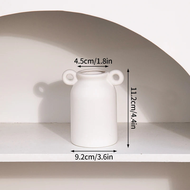 White ceramic vase with twin loop handles; retro desktop decor, 11.2 cm tall, 9.2 cm wide.