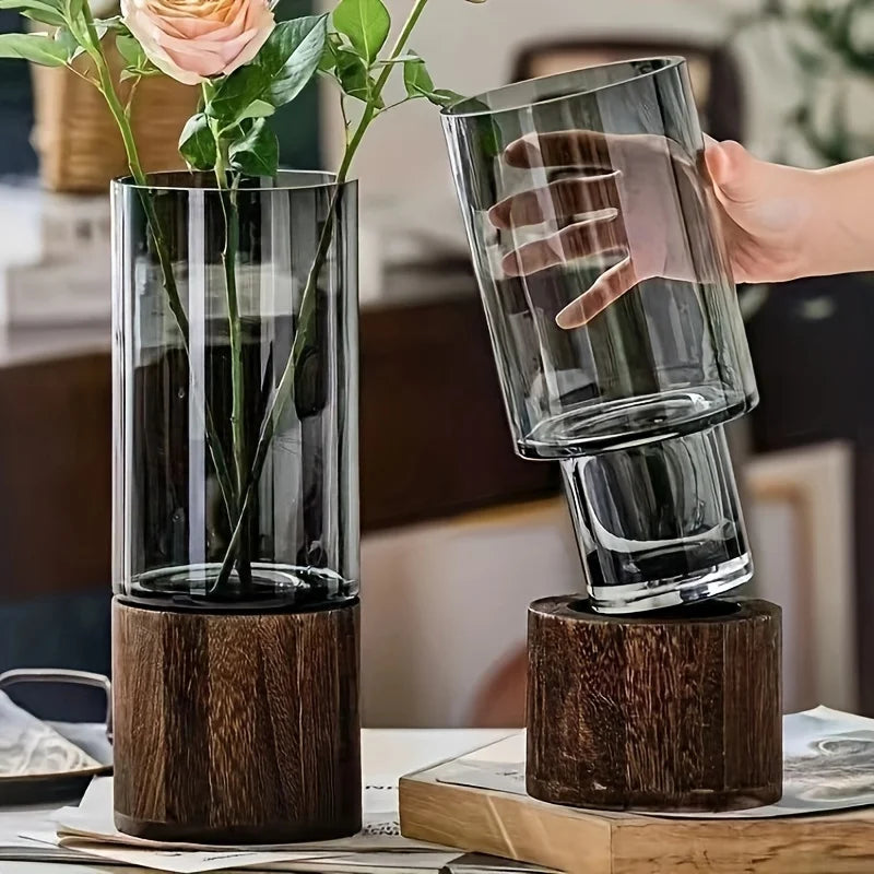 Pair of elegant glass vases with wooden bases for hydroponic plants; modern tabletop floral display.