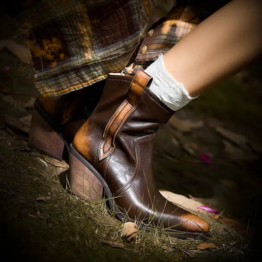 Premium leather western ankle boots with pointed toe, dark brown with tan contrast panel and stacked heel.