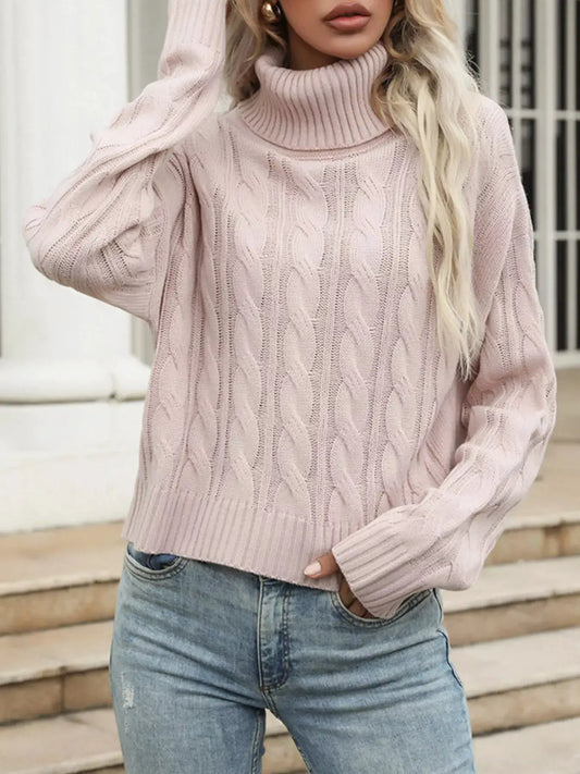 Cozy cable-knit turtleneck sweater in soft pink with ribbed cuffs and hem