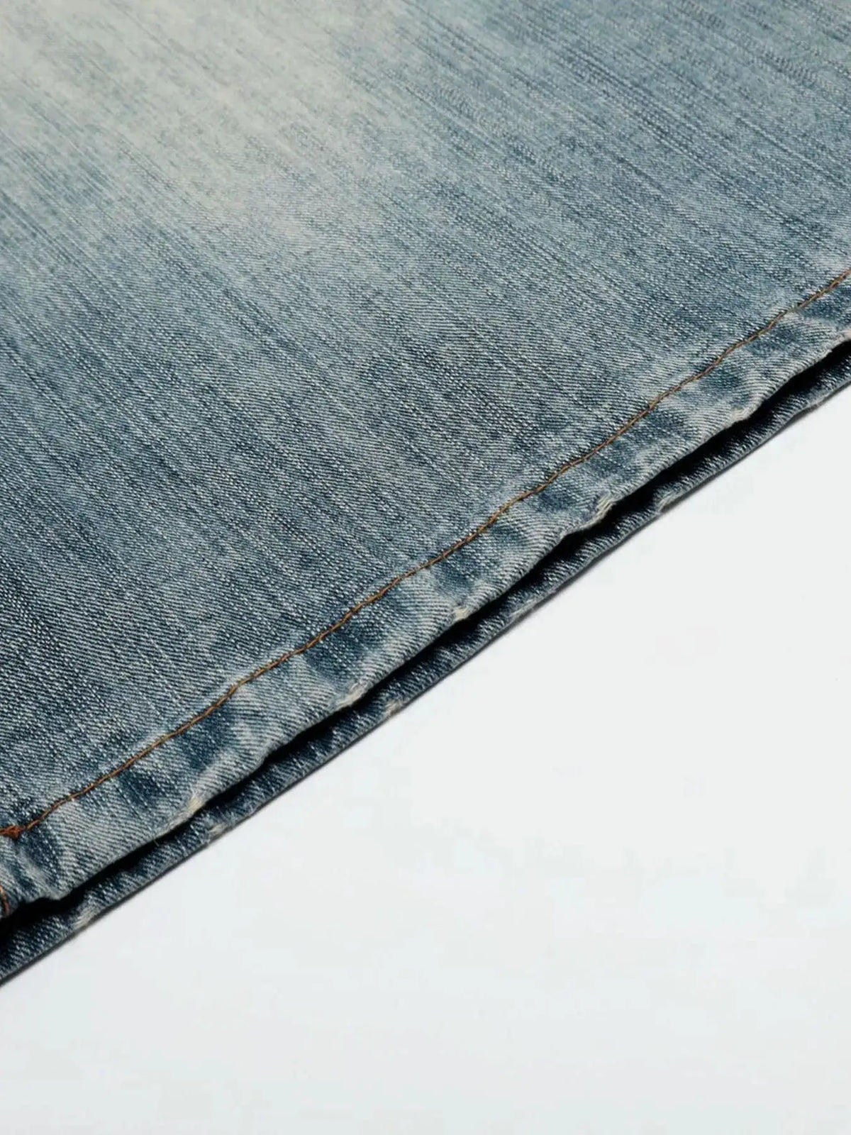 Mens wide-leg washed denim shorts in light blue denim with orange stitching along the hem.
