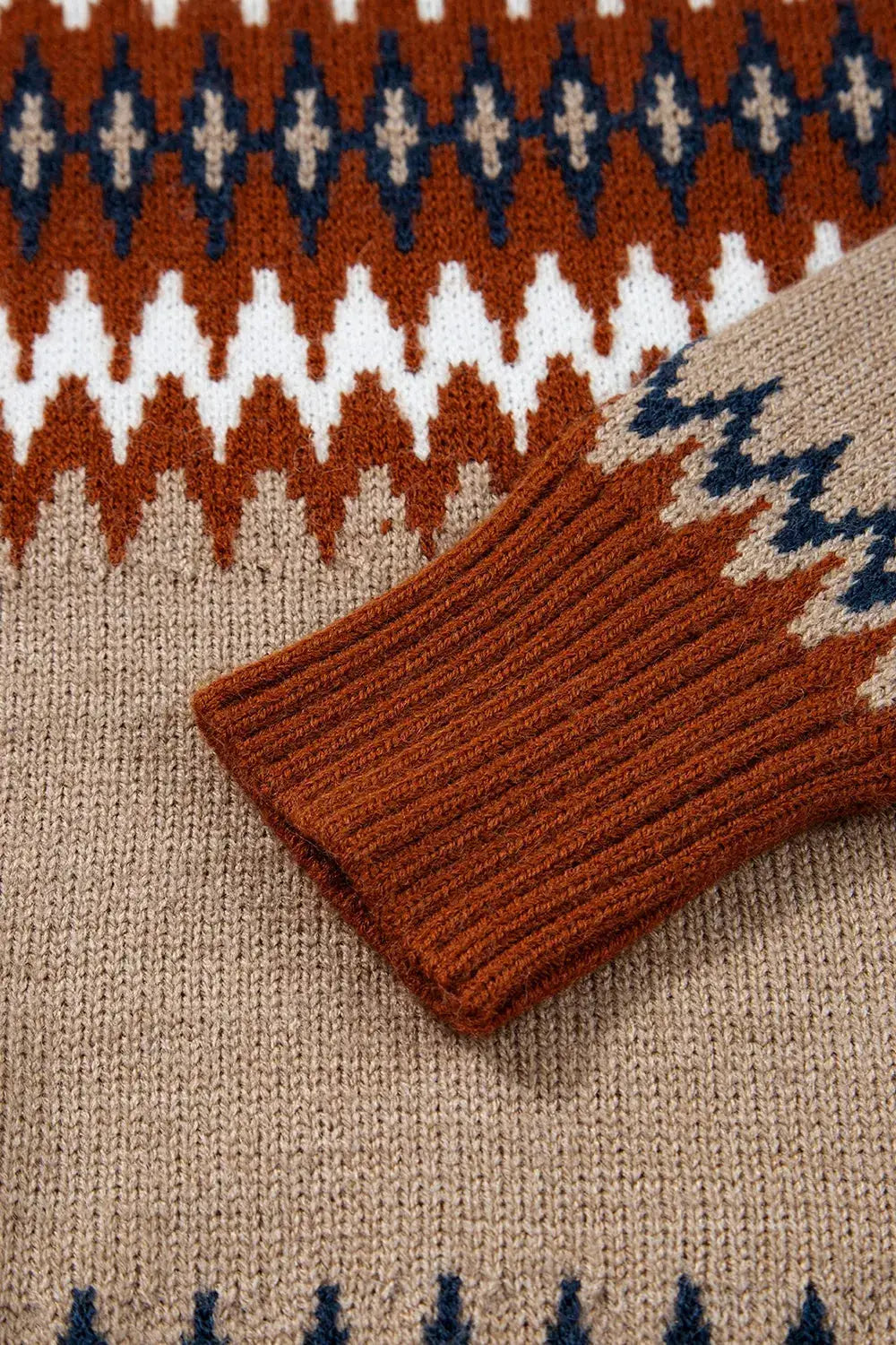 Geometric pattern long-sleeve knitted sweater in rust, beige, and navy with ribbed cuffs