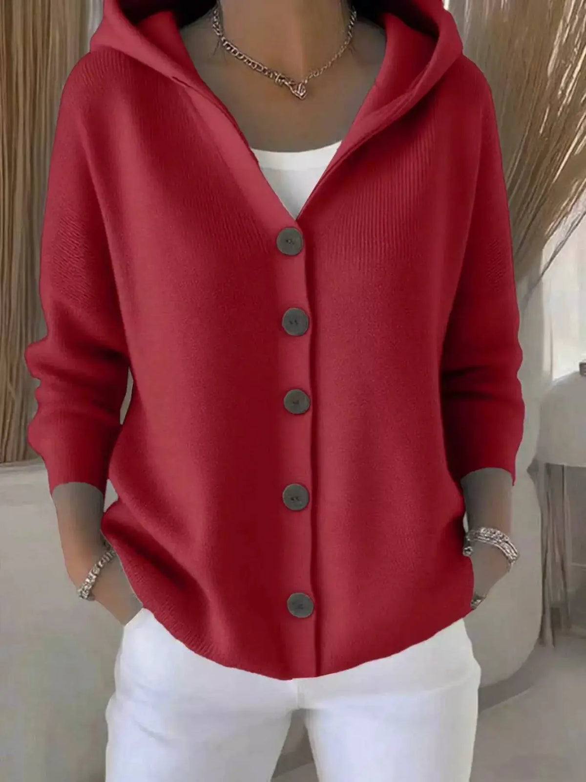 Plus Size Hooded Button Front Soft Knit Cardigan in red by Trendsi worn over a white top