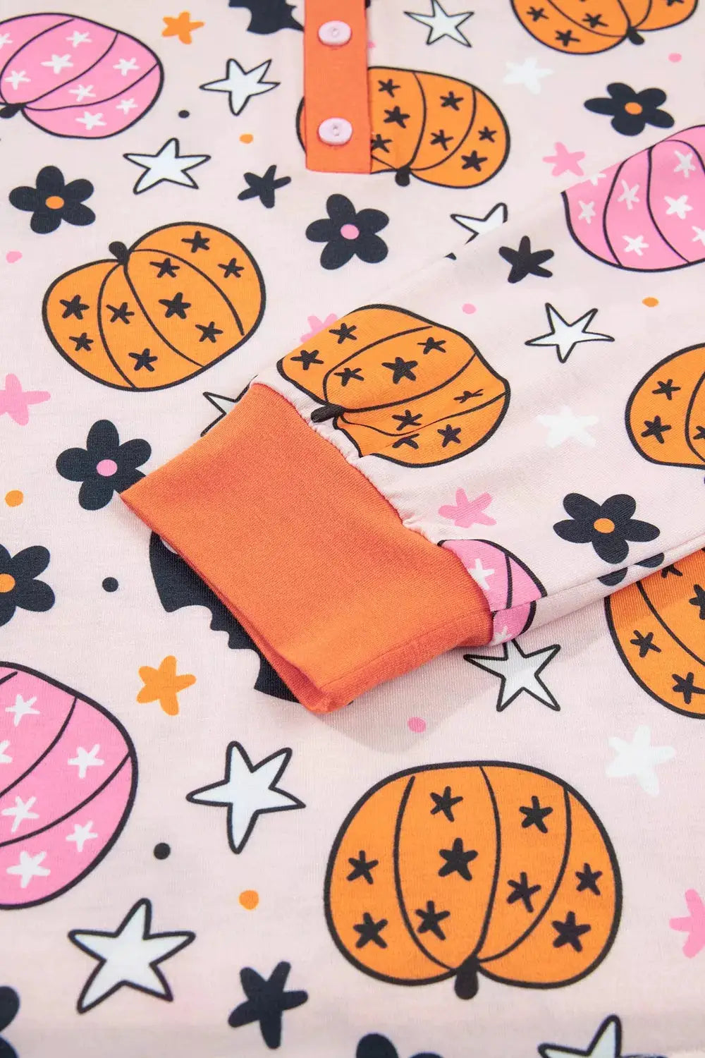 Halloween pumpkin print long-sleeve lounge set by Trendsi on pink background with orange cuffs
