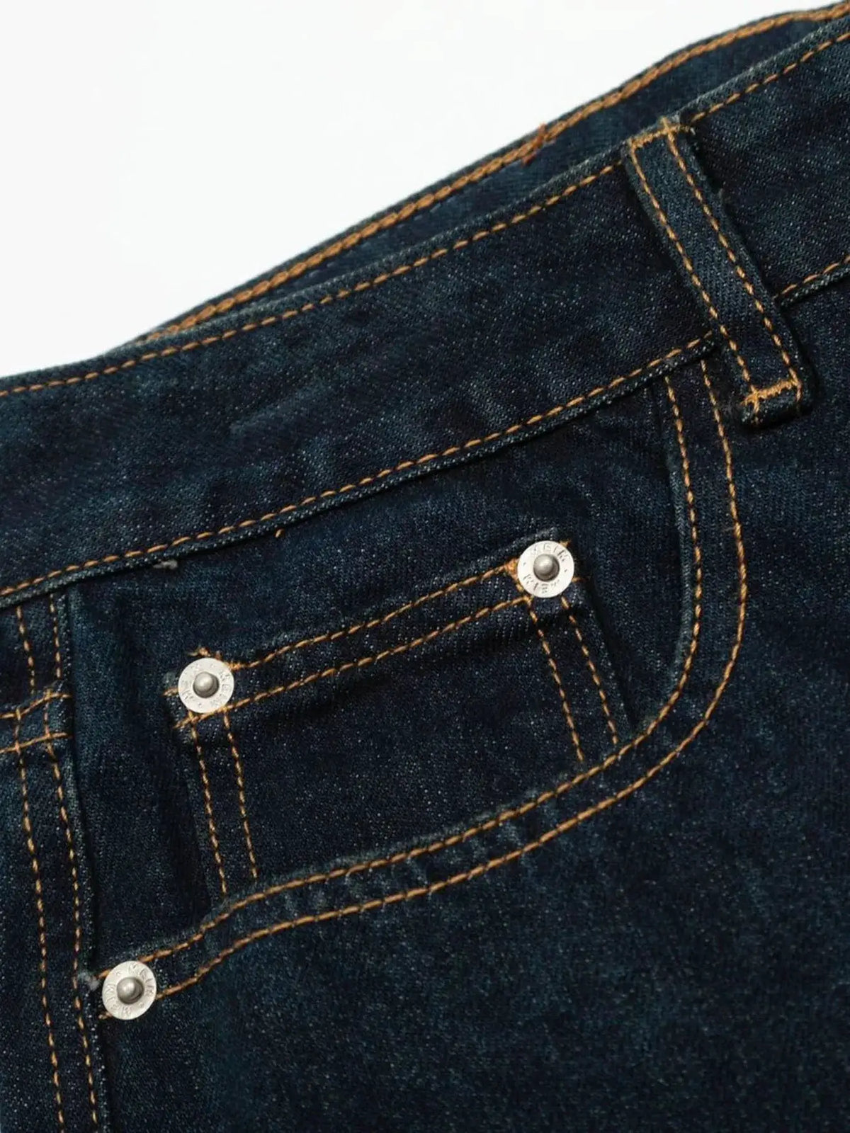 Oversized men's wide-leg denim shorts, dark indigo cotton with orange stitching and rivets.