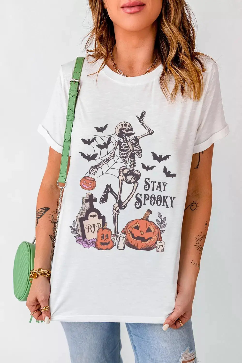 White graphic Halloween T-shirt featuring skeleton, pumpkins and bats with Stay Spooky text