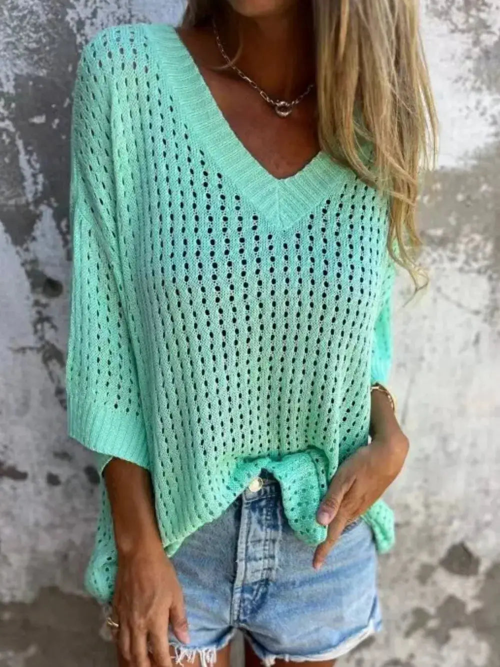 Plus size openwork V-neck knit cover-up in mint green, lightweight and stretchy, worn over denim shorts