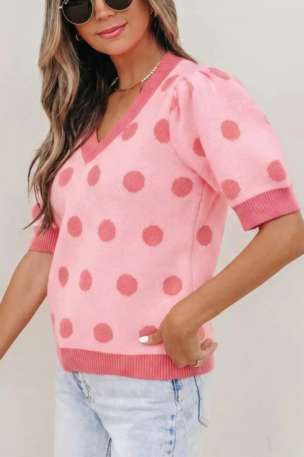 Chic polka dot puff-sleeve knit sweater top in pink with darker pink dots.