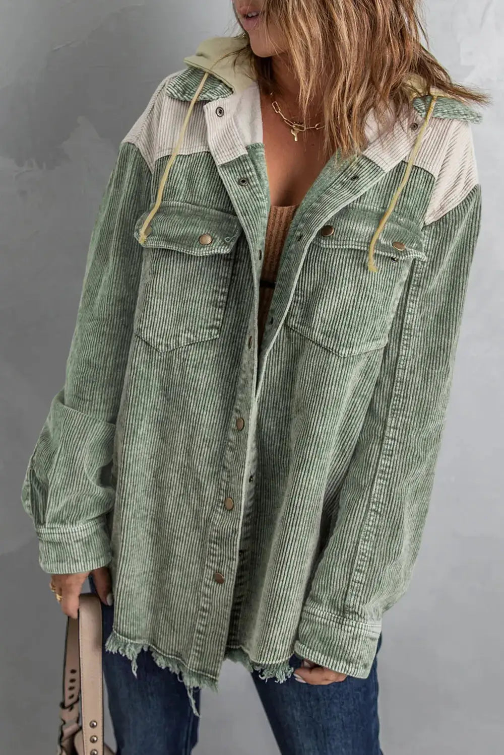 Snap Front Hooded Corduroy Shacket in sage green with cream color-block yoke panels, oversized fit, frayed hem